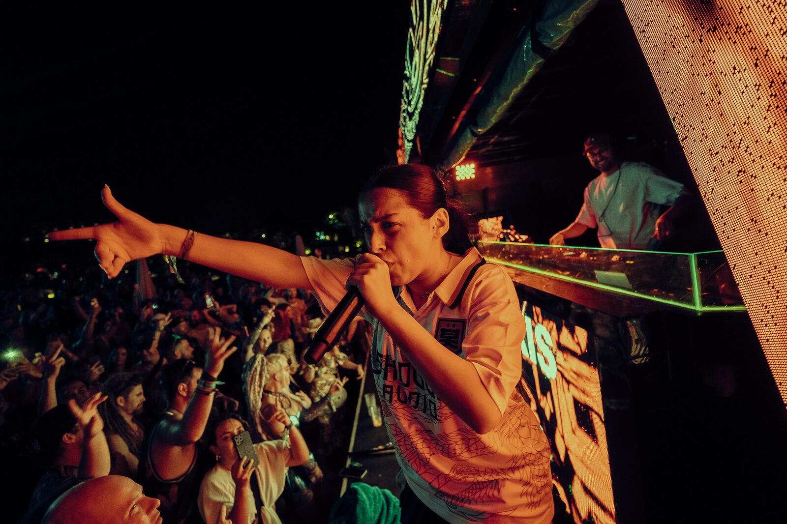 MC on the microphone pointing into the crowd at LOCUS Bali 2025